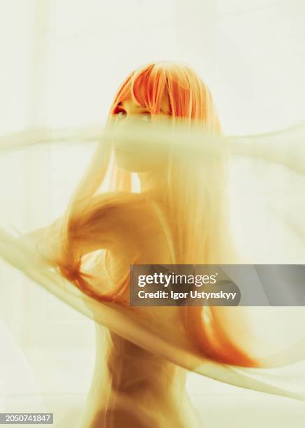 young woman looking through sheer fabric - sheer fabric stock pictures, royalty-free photos & images