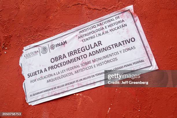 Merida, Mexico, historic district, zoning permit violation notice posted, sign.