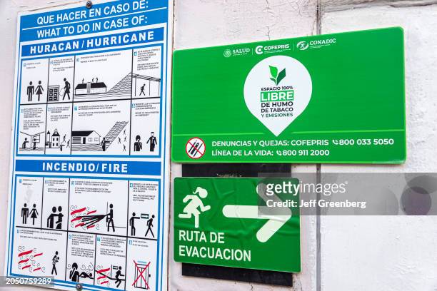 Merida, Mexico, Zona Paseo Montejo Centro, bilingual information signs, hurricane fire evacuation route, no smoking area.