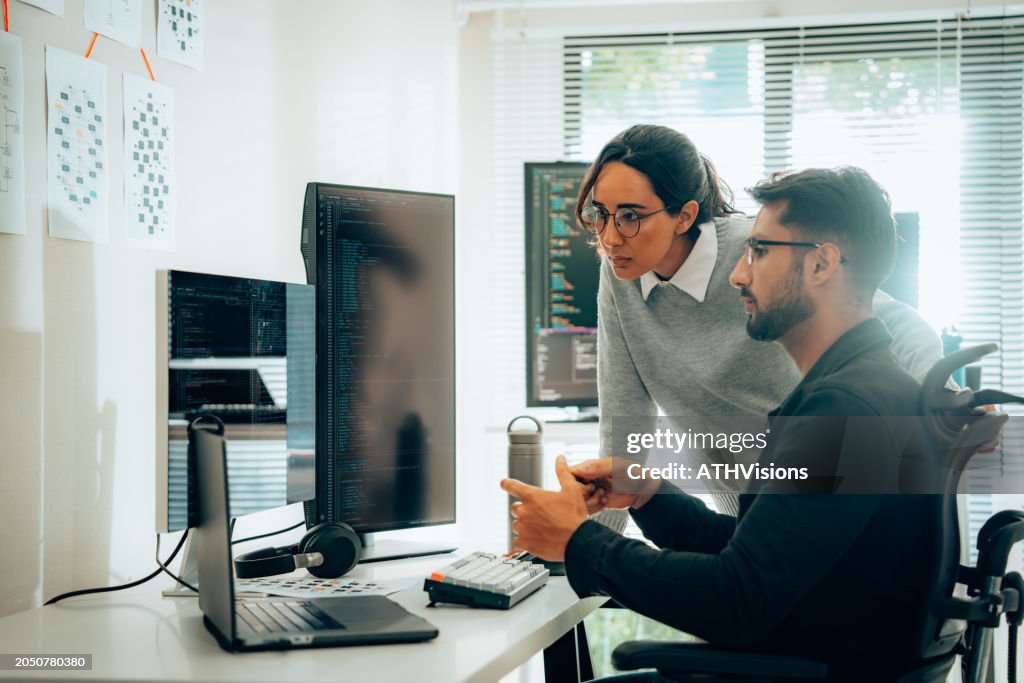 Hispanic Programmers Collaborating on Software Development in a Modern Office Setting
