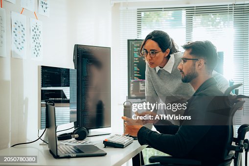 Hispanic Programmers Collaborating on Software Development in a Modern Office Setting Hispanic Programmers Collaborating on Software Development in a Modern Office Setting