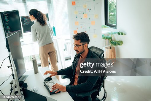 Hispanic Programmers Collaborating on Software Development in a Modern Office Setting Hispanic Programmers Collaborating on Software Development in a Modern Office Setting