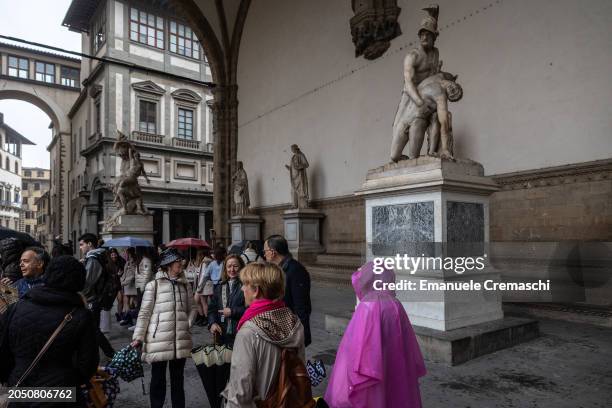 People stand next to the Pasquino Group while visiting the Loggia dei Lanzi on March 01, 2024 in Florence, Italy. The historic centre of Florence,...