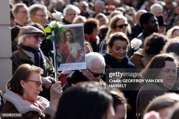 Protester holds a religious image during a demonstration against abortion and euthanasia, called by the association "La Marche pour la vie" in...