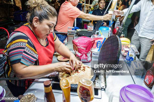 Merida, Mexico, historic district, Calle 60, marquesita crepe vendor, woman cooking with waffle pan.