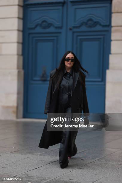 Jennifer Casimiro seen wearing Prada black Symbole sunglasses, Massimo Dutti black leather buttoned shirt, Ducie London black leather long coat, Zara...