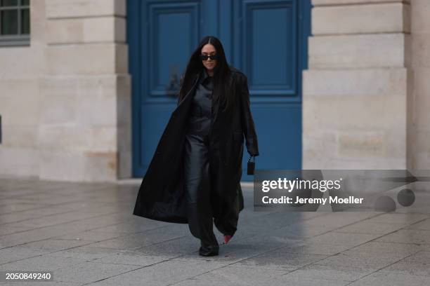 Jennifer Casimiro seen wearing Prada black Symbole sunglasses, Massimo Dutti black leather buttoned shirt, Ducie London black leather long coat, Zara...