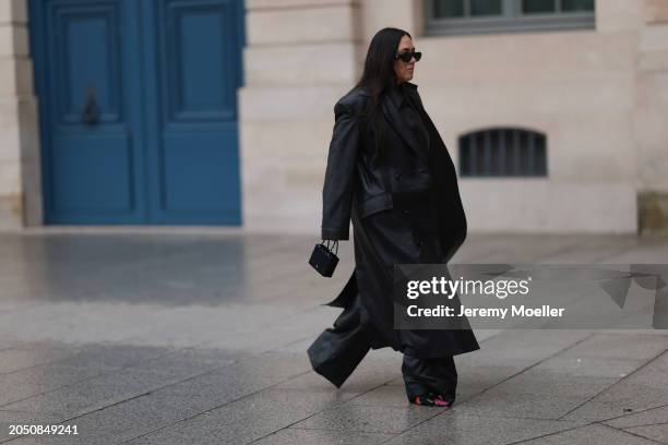 Jennifer Casimiro seen wearing Prada black Symbole sunglasses, Massimo Dutti black leather buttoned shirt, Ducie London black leather long coat, Zara...