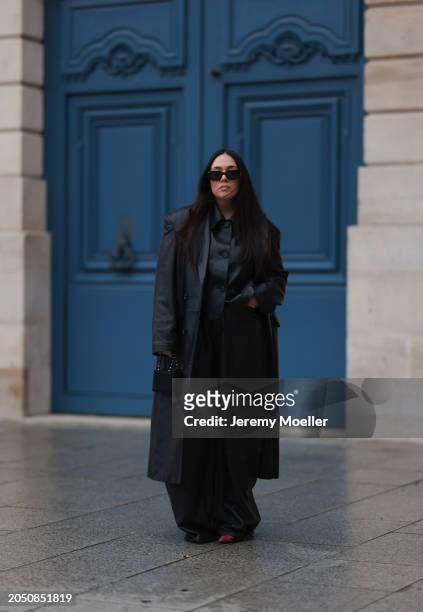 Jennifer Casimiro seen wearing Prada black Symbole sunglasses, Massimo Dutti black leather buttoned shirt, Ducie London black leather long coat, Zara...