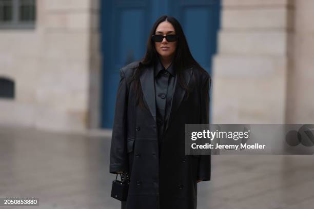 Jennifer Casimiro seen wearing Prada black Symbole sunglasses, Massimo Dutti black leather buttoned shirt, Ducie London black leather long coat and...