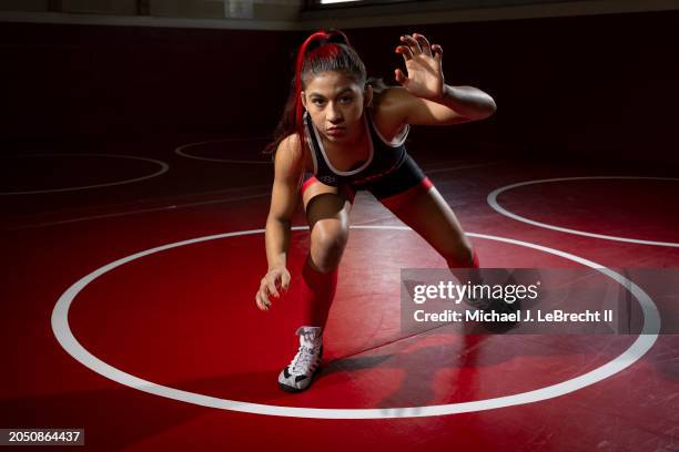 High School Wrestling: High school wrestler Taina Fernandez in action, poses for a portrait on the wrestling mats at Archbishop Spalding High School....