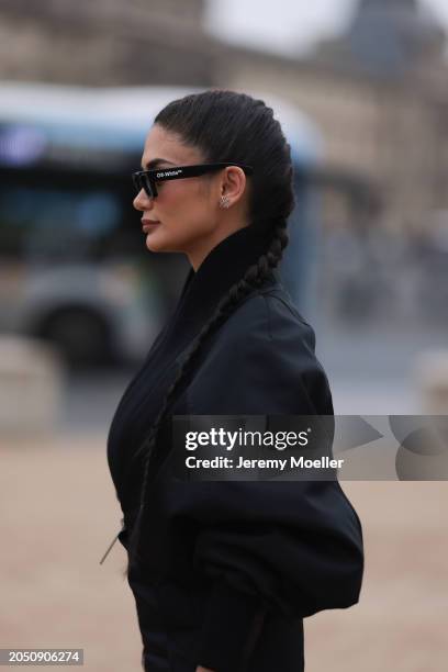 Pia Jauncey is seen wearing black leather high heels, black Off White shades, a black bag with a silver ornament on it and a fluffy black jacket...