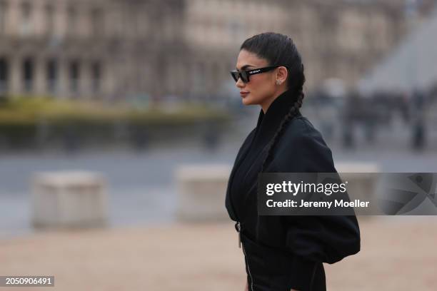 Pia Jauncey is seen wearing black leather high heels, black Off White shades, a black bag with a silver ornament on it and a fluffy black jacket...