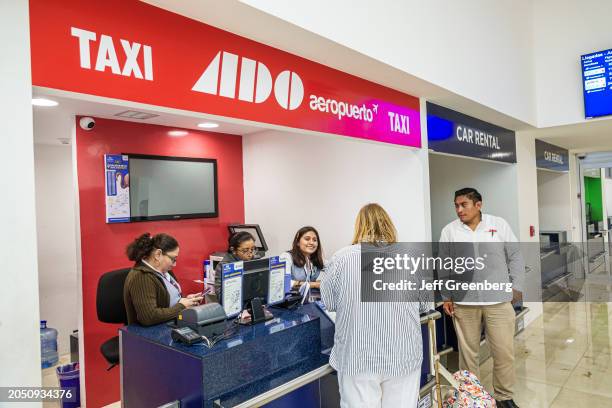 Merida, Mexico, Merida International Airport, Aeroporto Internacional Manuel Crescencio Rejon, traveler at ADO Aeroporto Taxi information booth.