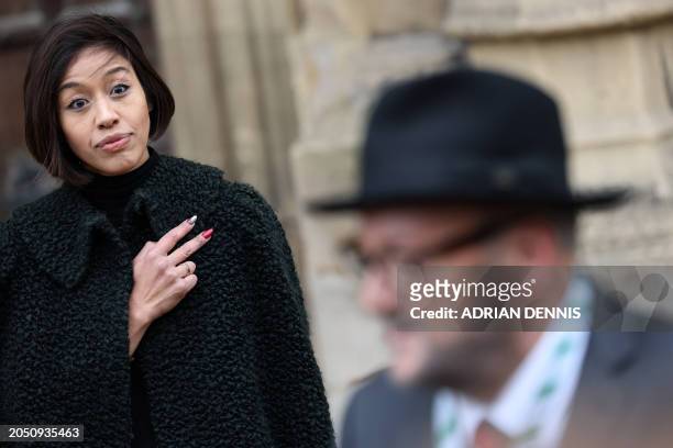 Putri Gayatri Pertiwi , the wife of newly elected Rochdale MP George Galloway, listens as he makes a statement to members of the media outside of the...