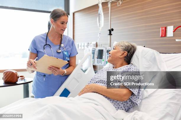 female doctor asks female hospital patient questions - neurodegenerative disease stock pictures, royalty-free photos & images