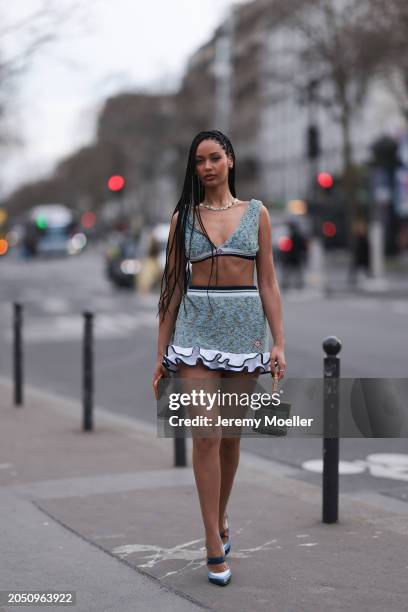 Jamilla Strand was seen wearing blue heels, a green skirt with fluffy ending as well as a cropped green top along with a green casablanca bag before...