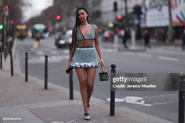 Jamilla Strand was seen wearing blue heels, a green skirt with fluffy ending as well as a cropped green top along with a green casablanca bag before...