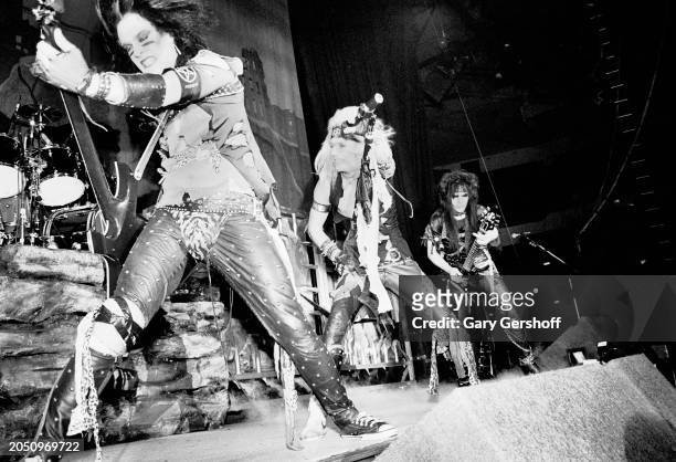 Members of American Heavy Metal group Motley Crue perform onstage, during the 'Shout at the Devil' tour, at Nassau Coliseum , Uniondale, New York,...