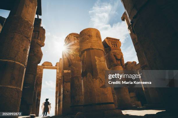 a woman visits the temple of hatshepsut in luxor, egypt. - old ruin stock pictures, royalty-free photos & images