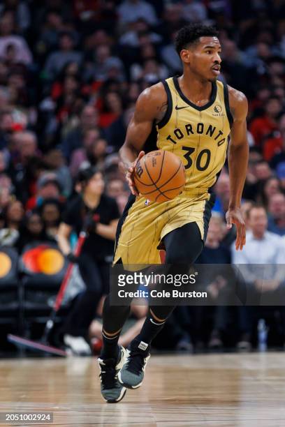 Ochai Agbaji of the Toronto Raptors dribbles against the Brooklyn Nets in the first half of the NBA game at Scotiabank Arena on February 22, 2024 in...