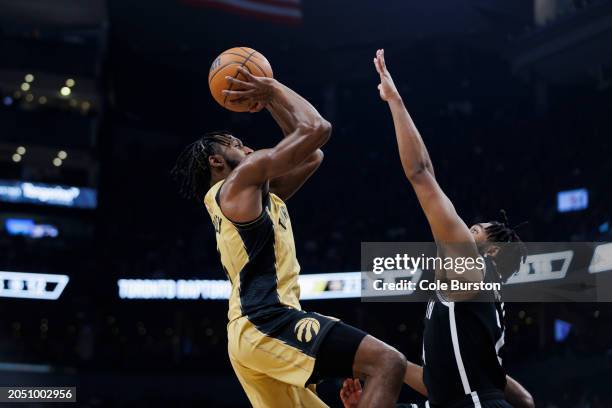 Immanuel Quickley of the Toronto Raptors puts up a shot over Cam Thomas of the Brooklyn Nets in the first half of the NBA game at Scotiabank Arena on...