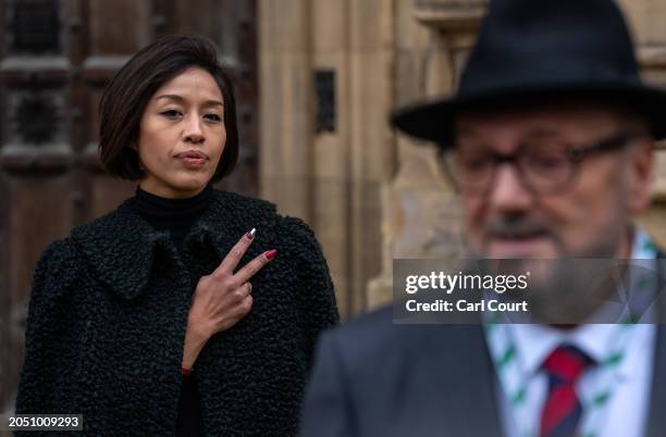 Putri Gayatri Pertiwi holds up her fingers to show the Palestine flag painted on a nail as her husband George Galloway, the newly-elected Workers...