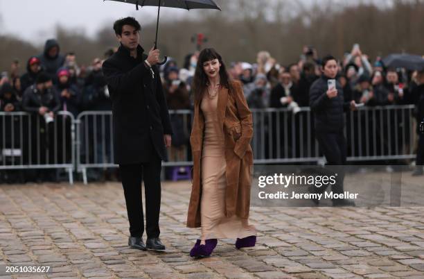 Ursula Corbero seen wearing beige sheer long dress, brown suede leather long coat, Loewe beige / brown leather bag and Loewe purple fluffy pumps /...