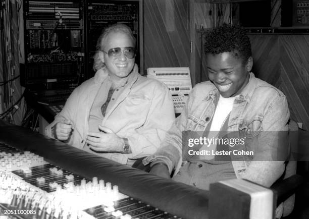 American record producer David Kershenbaum and American singer-songwriter Tracy Chapman sit in a recording studio in Los Angeles, California, circa...