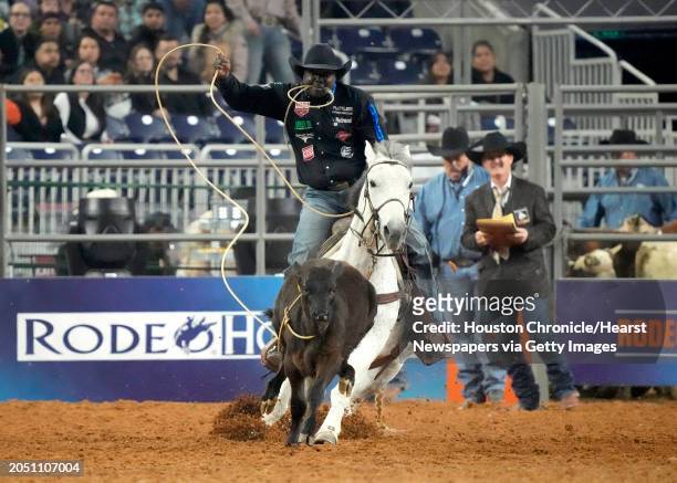 John Douch ropes a calf in the tie-down competition during the Super Series I, round 3 of Rodeo Houston at the Houston Livestock Show and Rodeo at...