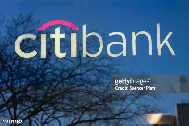Sign for CitiBank is seen on a window in Manhattan on March 01, 2024 in New York City. According to filings with the State Labor Department,...