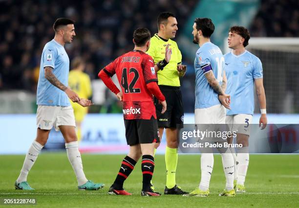Referee Marco Di Bello speaks with Alessandro Florenzi of AC Milan and Luis Alberto of SS Lazio during the Serie A TIM match between SS Lazio and AC...