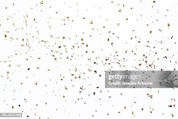 golden confetti on the white background - confete imagens e fotografias de stock