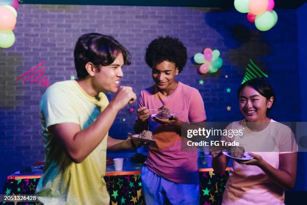 friends eating birthday cake at home - boy girl balloon stock pictures, royalty-free photos & images