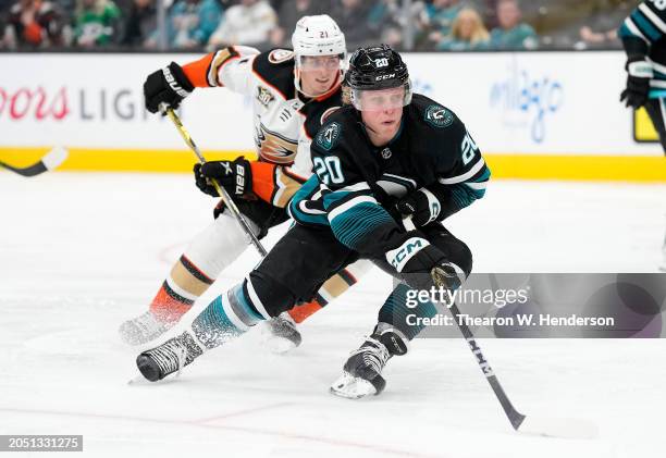 Fabian Zetterlund of the San Jose Sharks skates with the puck pursued by Isac Lundestrom of the Anaheim Ducks in the third period of an NHL hockey...