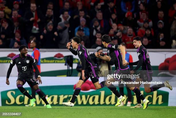 Jamal Musiala of Bayern Munich celebrates scoring his team's second goal with teammates during the Bundesliga match between Sport-Club Freiburg and...