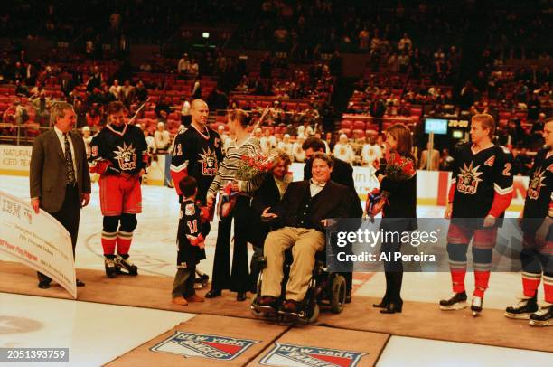 Christopher Reeve is presented with a $50,000 check for the Christopher Reeve Foundation by IBM and The New York Rangers as part of the IBM Power...