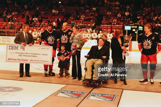 Christopher Reeve is presented with a $50,000 check for the Christopher Reeve Foundation by IBM and The New York Rangers as part of the IBM Power...