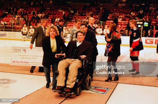 Christopher Reeve is presented with a $50,000 check for the Christopher Reeve Foundation by IBM and The New York Rangers as part of the IBM Power...