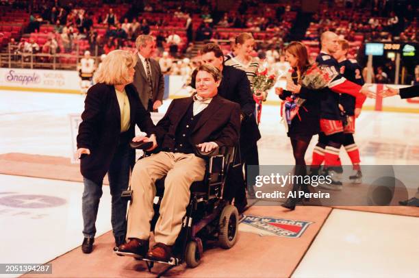 Christopher Reeve is presented with a $50,000 check for the Christopher Reeve Foundation by IBM and The New York Rangers as part of the IBM Power...