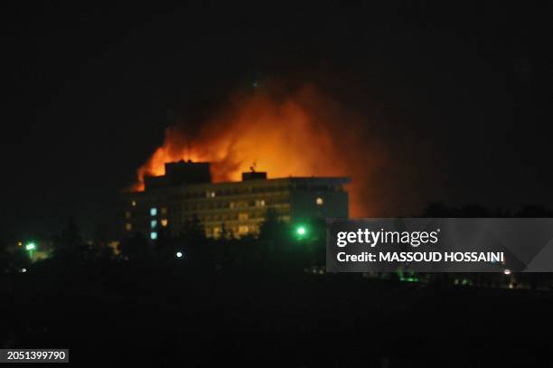 Smoke and flames light up the night from a blaze at the Intercontinental hotel after an attack on the hotel by Taliban fighters and a response by...