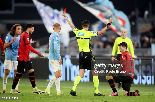 Referee Marco Di Bello shows a red card to Matteo Guendouzi of SS Lazio as Christian Pulisic of AC Milan is shown a yellow card during the Serie A...