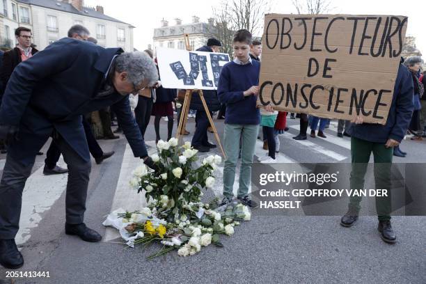 Protesters hold a placard reading "conscientious objectors" during a demonstration against abortion and euthanasia, called by the association "La...