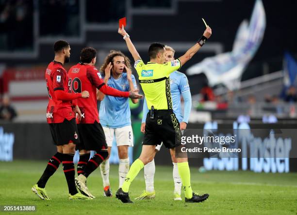 Referee Marco Di Bello shows a red card to Matteo Guendouzi of SS Lazio as Christian Pulisic of AC Milan is shown a yellow card during the Serie A...