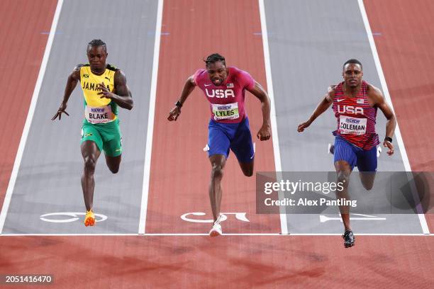 Ackeem Blake of Team Jamaica, Noah Lyles of Team United States and Christian Coleman of Team United States cross the finish line in the Men's 60...