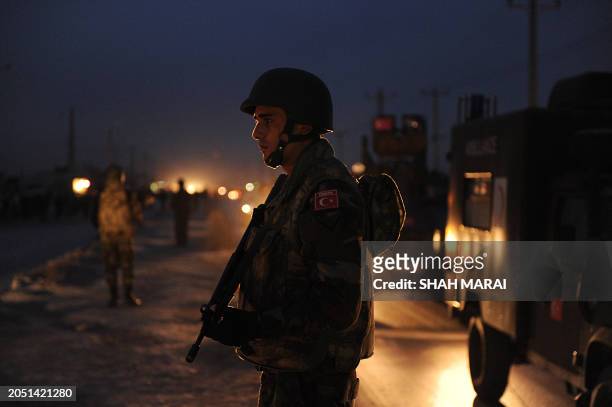 Turkish soldier with the NATO-led International Security Assistance Force stands guard at the site of a suicide attack near Camp Phoenix in Kabul on...