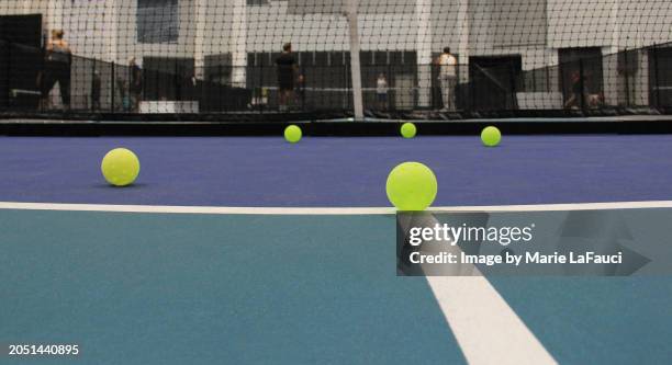 low-angle view of indoor pickleball court with balls - baseline stock pictures, royalty-free photos & images