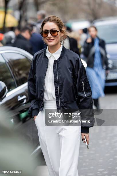 Olivia Palermo wears white pants, button shirt, black bomber jacket outside Nina Ricci during the Womenswear Fall/Winter 2024/2025 as part of Paris...