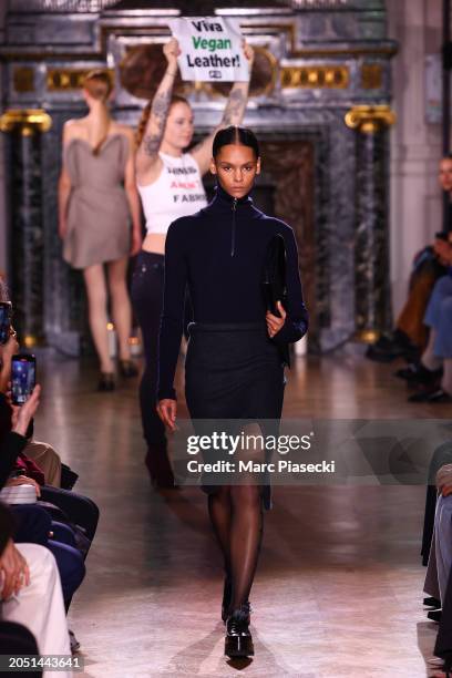 Peta activist is seen on the runways as a model walks during the Victoria Beckham Womenswear Fall/Winter 2024-2025 show as part of Paris Fashion Week...