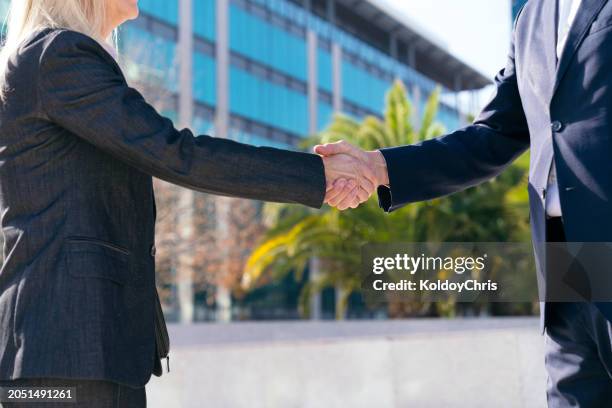 close-up of a firm handshake between business partners - contracting stock pictures, royalty-free photos & images